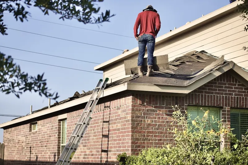 Professional roofer working on a residential roof in Upper Fairfax